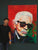 Artist Marcel Kozik standing beside his original Karl Lagerfeld empathic portrait, a 120×160 cm expressive acrylic painting with bold red and green textured strokes.